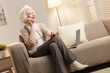 © View Stock - Elderly people sitting on couch talking on the phone