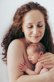 Fototapeta  - Mother holding her newborn