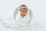 Fototapeta  - Newborn baby wrapped in bucket