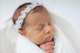 Fototapeta Tęcza - Newborn baby girl closeup portrait