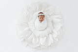 Fototapeta Tęcza - Newborn baby girl in flower