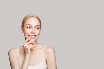 Wall Mural - Portrait of cute laughing woman with healthy clear skin. Facial treatment, skincare and cosmetology concept