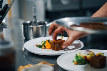 chef dishing up steak in a professional kitchen