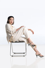 Fashionable Young Woman Posing On Chair
