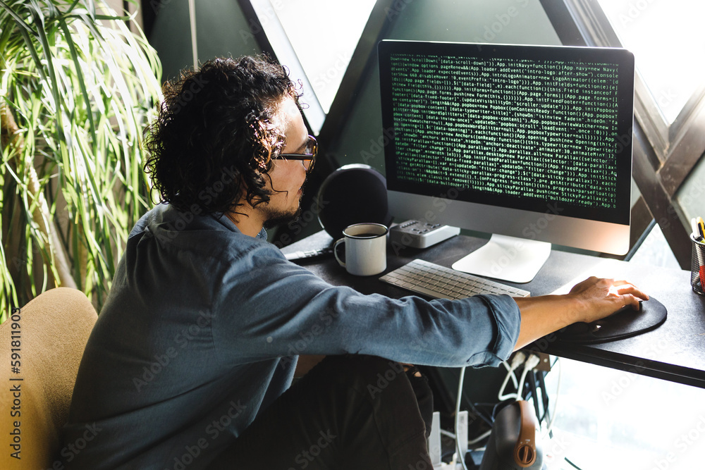 latin man programmer writing program code on desktop computer sitting ...
