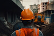 © ZoomTeam - an engineer in a helmet, with his back turned, supervises the construction. in the background construction machinery, excavators, trucks, ai generatiove