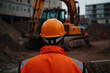 © ZoomTeam - an engineer in a helmet, with his back turned, supervises the construction. in the background construction machinery, excavators, trucks, ai generatiove