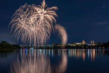 Poster - Beautiful view of fireworks in the night sky over the lake by the city