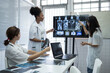 Leinwandbild Motiv Group of female medical scientists meeting in brain research lab by monitor showing MRI, CT scans brain images. Group of doctors discuss treatment for brain patients, showing images on monitor