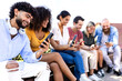 © Xavier Lorenzo - Young group of people using cell phone together while sitting in city street. Diverse friends sharing content on social media networks thought phone mobile app. Technology and friendship concept