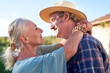 © Caia Image - Profile portrait happy senior couple hugging face to face