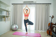 © visoot - Yoga at home,Attractive young woman doing exercises on fitness mat.