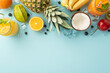 Refreshing escape concept. Top view of fresh fruit juice or cocktail in a glass jar kiwi, papaya, pineapple, granadilla, bananas on a blue background with an empty space for branding