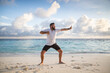 © Melinda Nagy - man practicing qigong by the sea