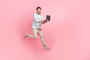 Sticker - Full length photo of cheerful excited man wear turquoise shirt chatting modern gadget empty space isolated pink color background