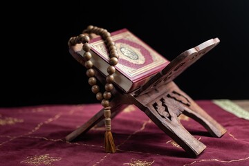 Wall Mural - Holy Book of Muslims with breads on dark background