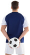 Rear view of sportsman holding football at his back