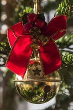 Golden Bauble With Ribbon On Christmas Tree; London, England