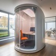 modern office pod with a monitor, desk and chair inside 