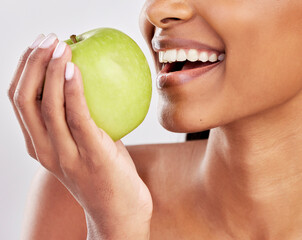 Sticker - Woman, apple in hand and health with nutrition and fruit closeup, healthy food and diet on studio background. Weight loss, organic and fresh produce with happy female mouth, wellness and lifestyle