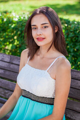 Wall Mural - Portrait of a young beautiful brunette  girl in summer park