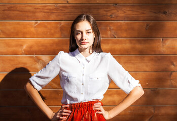 Wall Mural - Young teenage brunette girl in white shirt