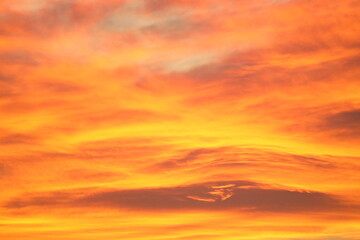 Blurry background of red   sunset sky. Dramatic sky with colorful cloud background. Red burning sunset sky.  Copy space.