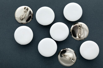 Blank white badges on grey background