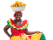 Happy, smiling Palenquera fresh fruit street vendor typical of Cartagena, Colombia, isolated in transparent PNG. Cheerful Afro-Colombian woman in traditional clothing, Colombian culture and lifestyle.