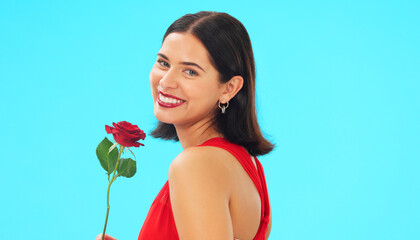 Poster - Face, rose and woman in studio on blue background with fresh, floral or romantic gesture on mockup. Portrait, flower and female with gift, present and romance, valentines or caring offering isolated