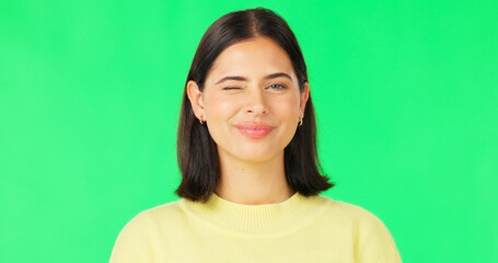 Wall Mural - Happy, woman and face wink on green screen, studio and color background. Portrait, female model and winking with smile of cool girl, fun mood and joyful personality in happiness, emoji and flirting