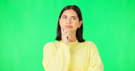 Wall Mural - Mind, thinking and decision with a woman on a green screen background in studio to consider an option. Idea, face and contemplating with an attractive young female looking thoughtful on chromakey