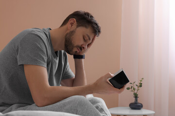 Poster - Sleepy man with clock in bed at home