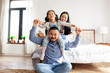 © Богдан Маліцький - Korean dad holds his little daughter in his arms and depicts flight, child plays with his parents and rejoices at home