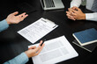 © Charlie's - Examiner reading a resume during job interview at office Business and human resources concept.