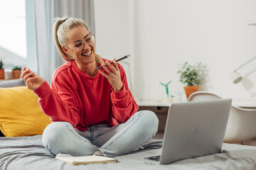 A female college student is having fun talking on the phone