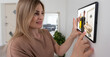 © Angelov - Delivery man ringing door bell on cctv secure camera system on tablet app