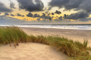 Canvas Print - Kitesurfing seen from the dunes at sunset