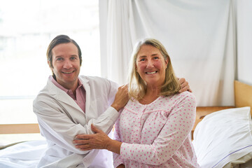 Wall Mural - Smiling doctor with elderly woman at rehab center