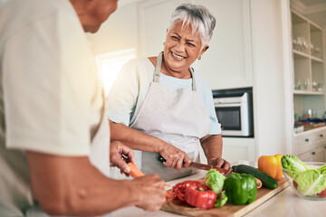 Canvas Print - Cooking vegetables, kitchen and senior couple cutting ingredients, prepare food and smile on romantic home date. Health nutritionist, culinary and hungry man, woman or people bonding over lunch meal