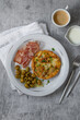 © Lizaveta - Homemade tortilla - Traditional  Spanish Omelette with potato in a plate on a grey background. Served with bacon and olives.