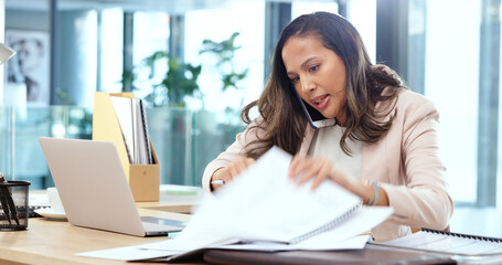Poster - Female advertising agent looking busy while talking on a phone call and searching through documents on a messy table in an office. Female marketing professional trying to find an important form