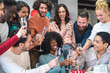 © MandriaPix - Group of friends toasting for a party and the festive young African American woman in the center, champagne and strawberry cake
