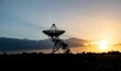© Kev Kindred/Wirestock Creators - Silhouette shot of a radio telescope dish on a field during sunset