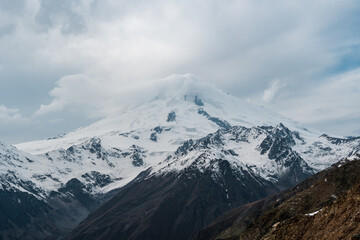 Wall Mural - View of the valley and Mount Elbrus in the cloud