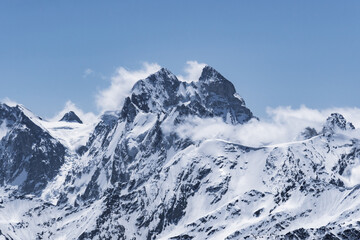 Wall Mural - View of Mount Ushba and snow-covered peaks on a cloudy day from the top of Mount Elbrus