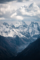 Wall Mural - View of the valley and Mount Ushba and snow-covered peaks on a cloudy day