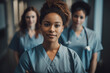 © ADDICTIVE STOCK - AI generated image of confident African American female doctor in medical uniform standing with blurred colleagues in hospital