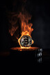 Burning bitcoin coin in a fire with smoke