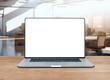 © Thongden_studio - blank screen of laptop on wood top table
